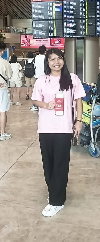 A helper at Changi Airport after arriving in Singapore