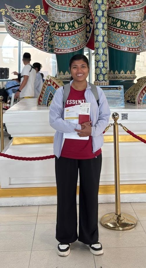 A helper holding her documents at the airport in transit